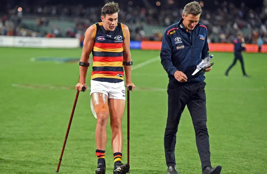 A professional AFL footballer having just injured his hamstring